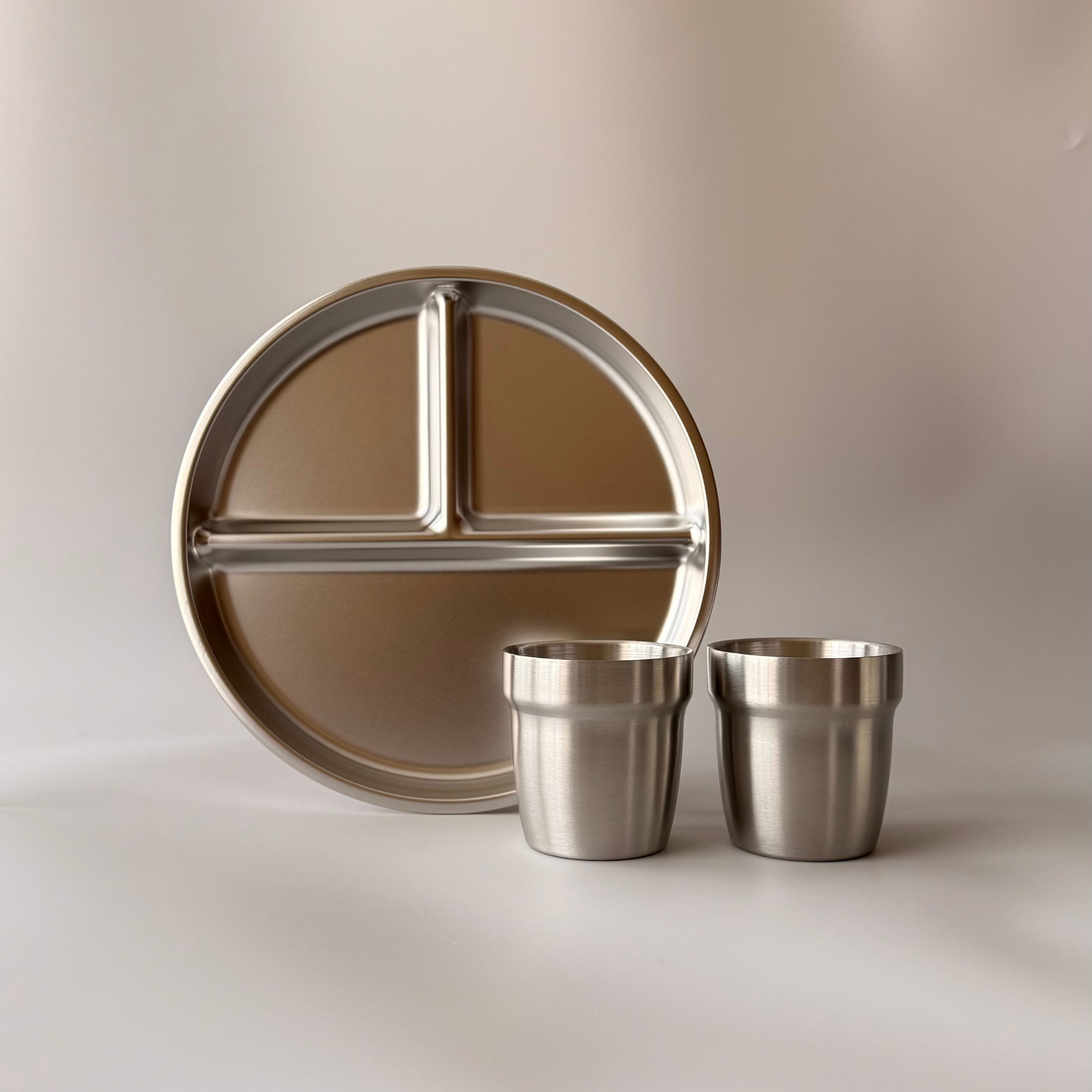 Complete A Kinder Nest Gentle Start Bundle featuring a 3-section stainless steel divided plate and insulated cup