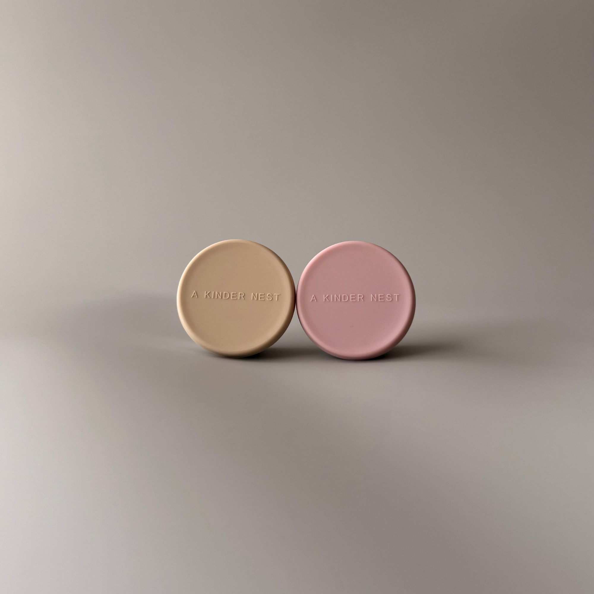 A Kinder Nest Duo containers nesting perfectly inside the larger Trio stainless steel food storage set.