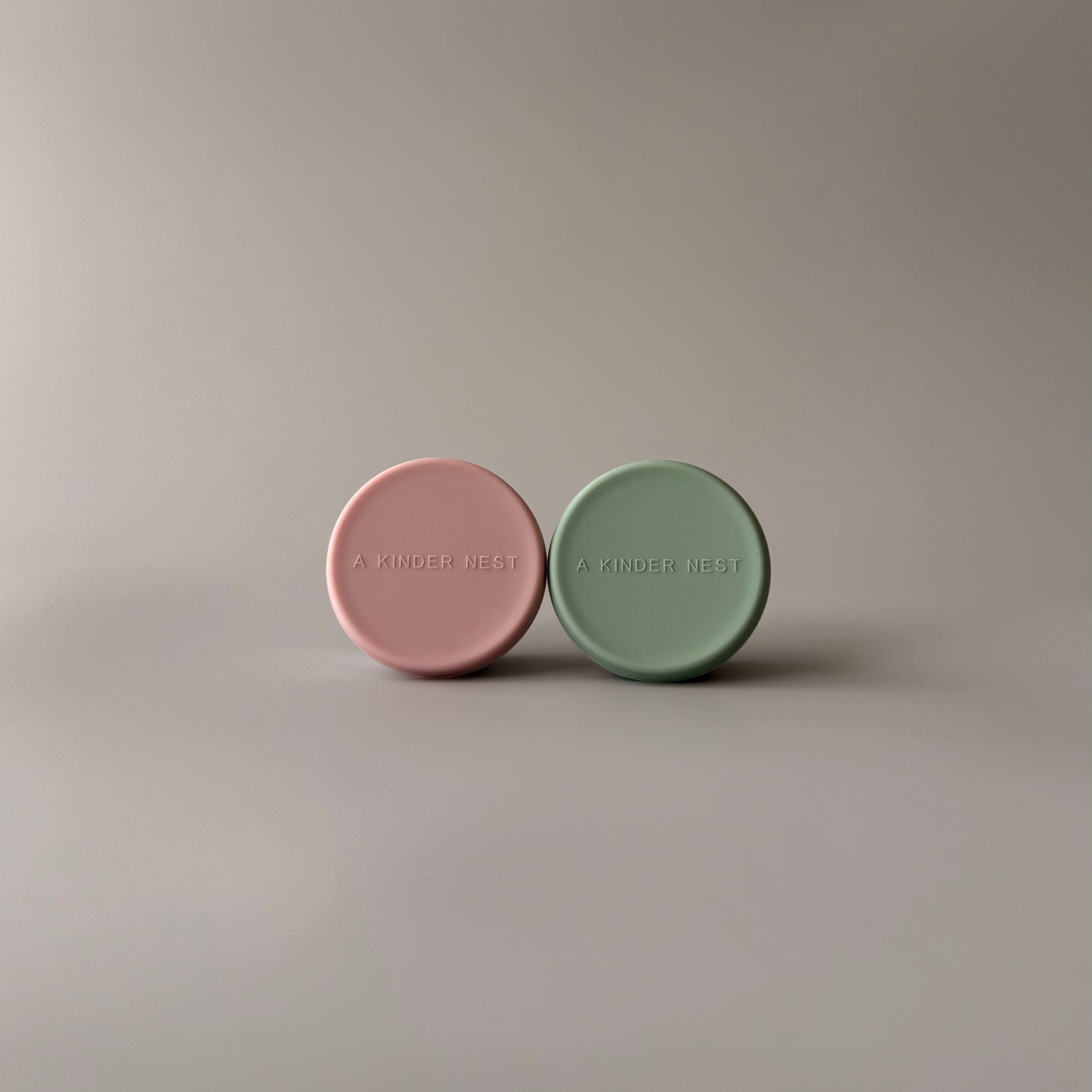 Hand-held view of a 60ml stainless steel mini container showing its compact and portable size for travel.