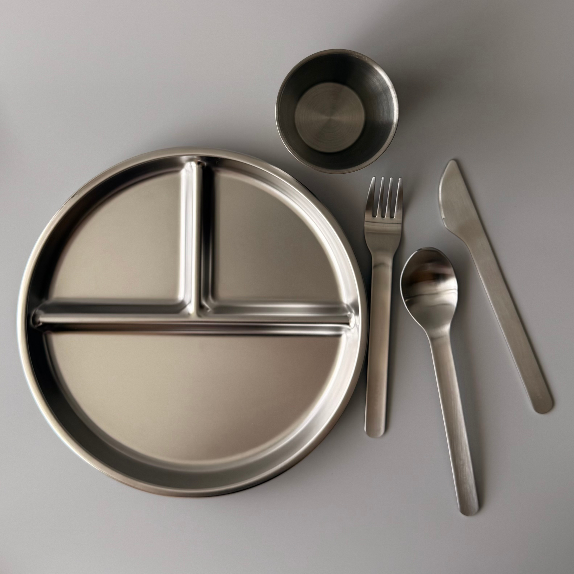 Close-up of the smooth, safe edges of a 304 food-grade stainless steel divided plate for children.