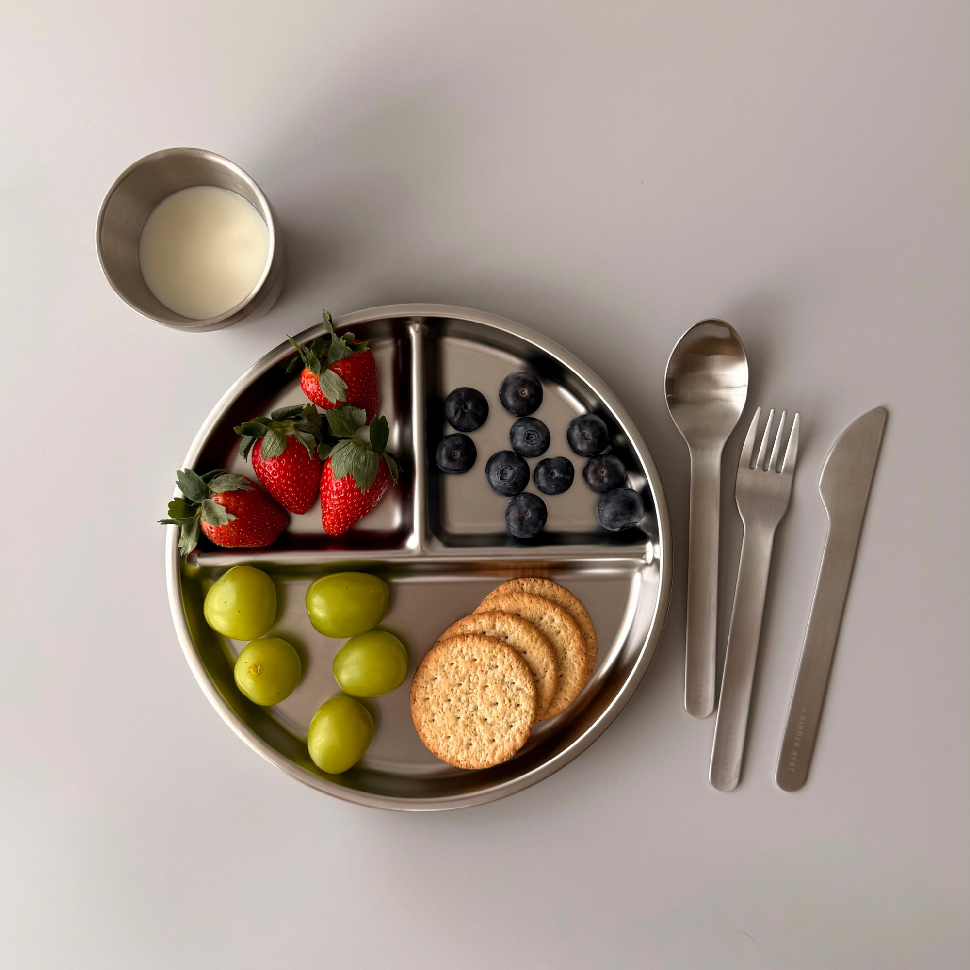 Stackable design of A Kinder Nest stainless steel plates showing easy, space-saving kitchen storage